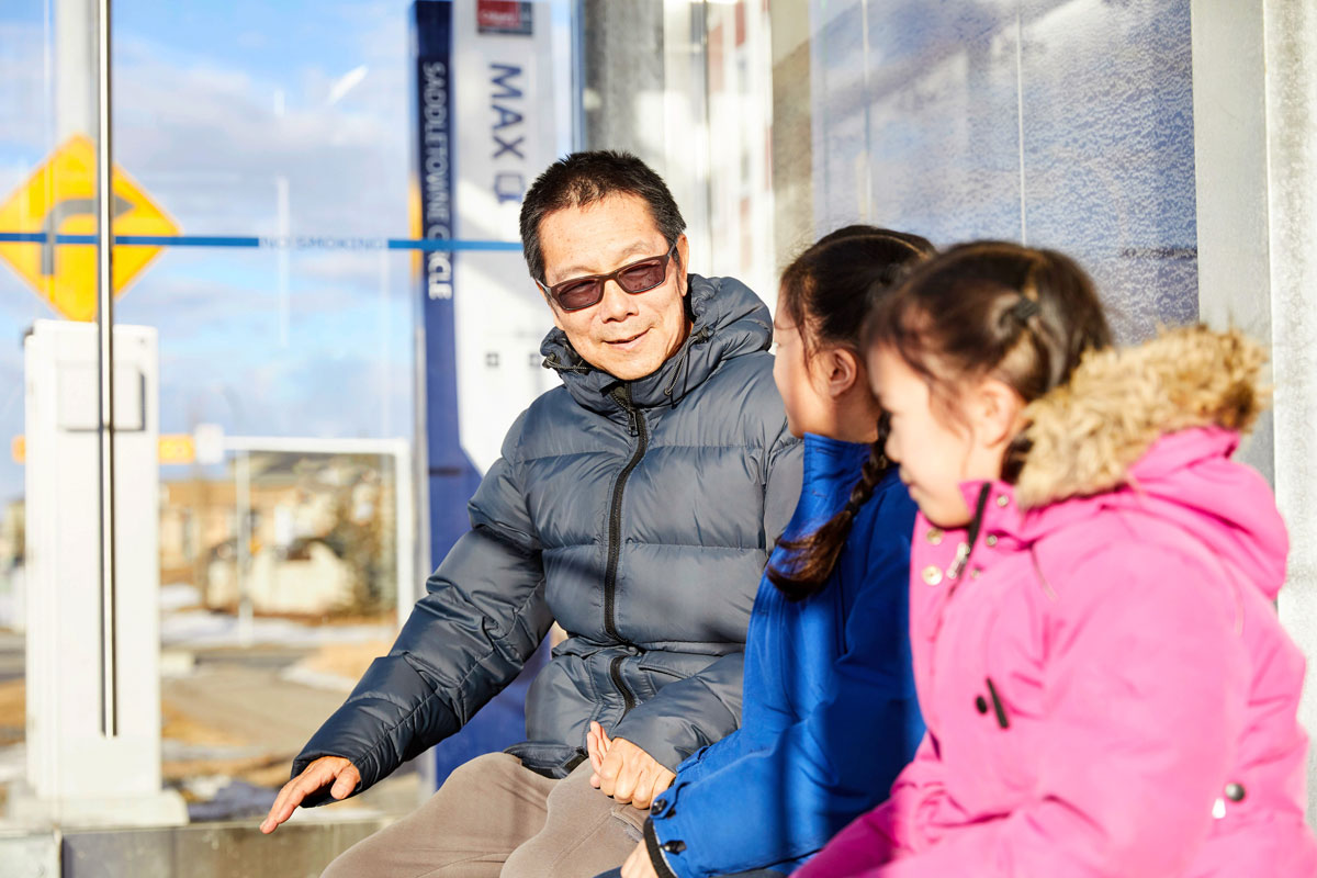 Family sitting at MAX Station